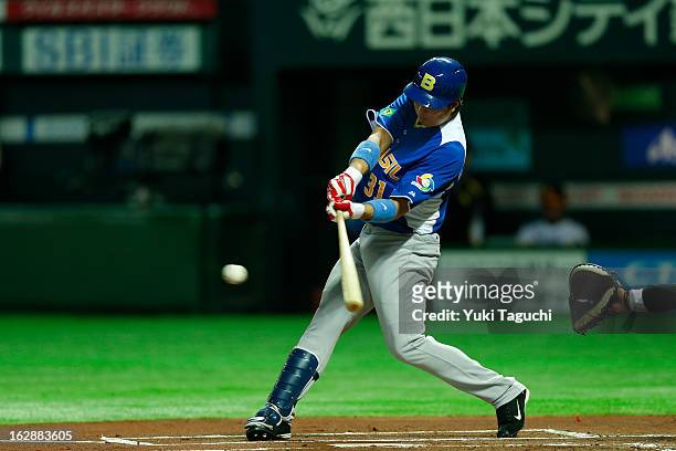 Daniel Matsumoto of Team Brazil bats during the World Baseball Classic exhibition game against the SoftBank Hawks at the Fukuoka Yahoo! Japan Dome on...