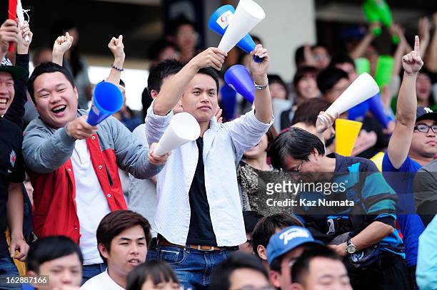 Fans are seen cheering in the stands during the World Baseball Classic exhibition game between Team Chinese Taipei and the NC Dinos at Taichung...