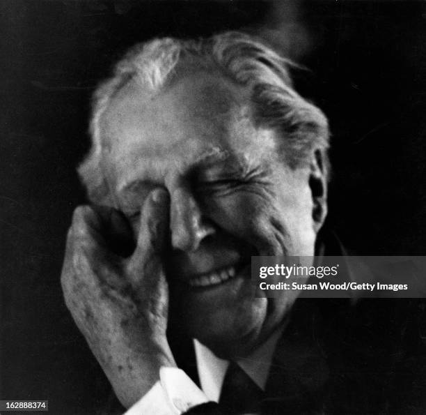 Portrait of American architect Frank Lloyd Wright as he laughs, one hand to his head, 1956.