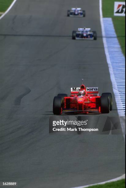 Michael Schumacher of Germany in his Ferrari leads from the two Williams-Renault's of Jacques Villeneuve of Canada and Heinz-Harald Frentzen of...
