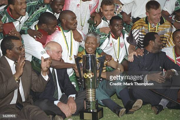 President Nelson Mandela celebrates with the South African players after their victory in the African Nations Cup Final against Tunisia in South...