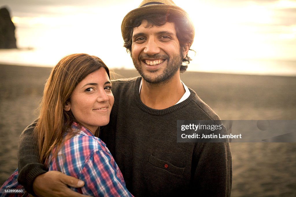 COUPLE EMBRACING AT THE BEACH