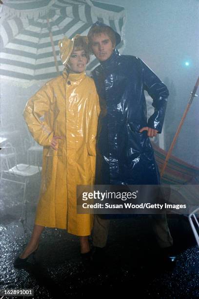Italian actress Monica Vitti and Terence Stamp, both dressed in a raincoats, in a scene from the film 'Modesty Blaise' , 1965.