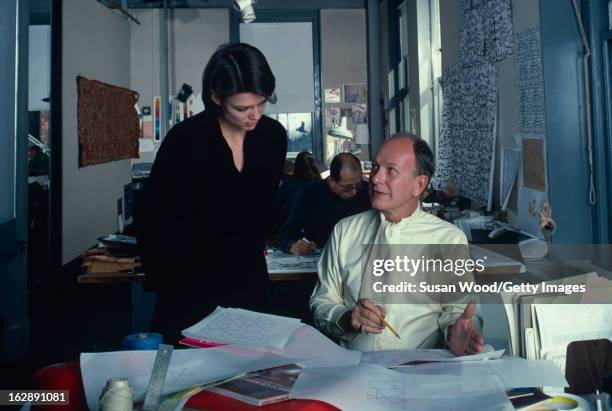 In his studio, American textile designer and author Jack Lenor Larsen talks with a collegue, New York, 1982.