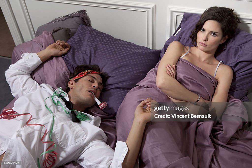 Couple in bed, the man drunk