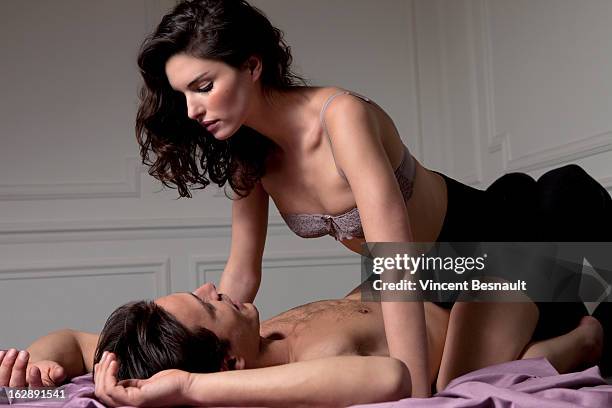 young woman in lingerie astride a man - seduzione foto e immagini stock