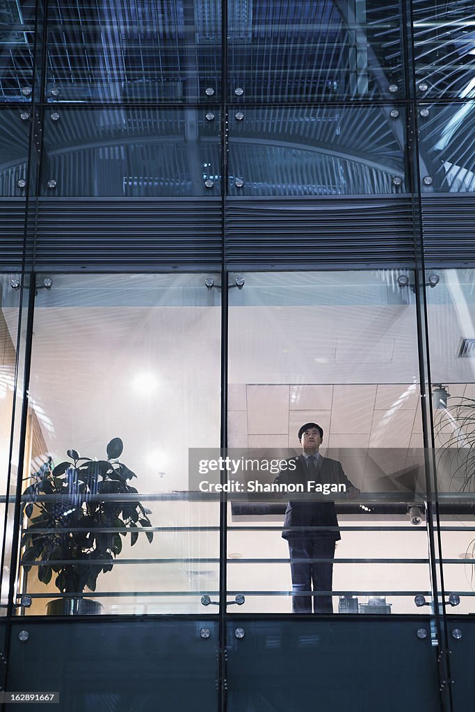 Businessman looking out of the office window