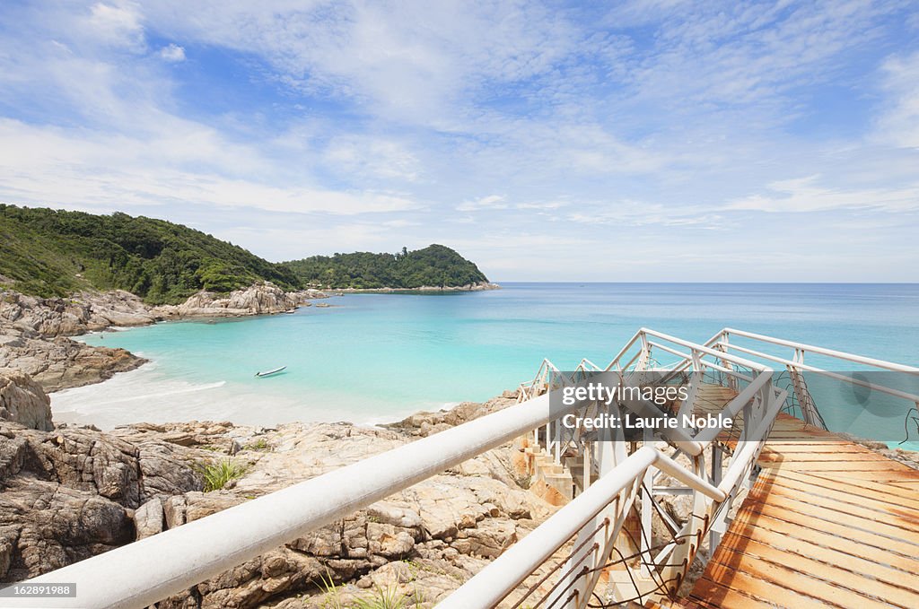 Delapidated pier leading to beach