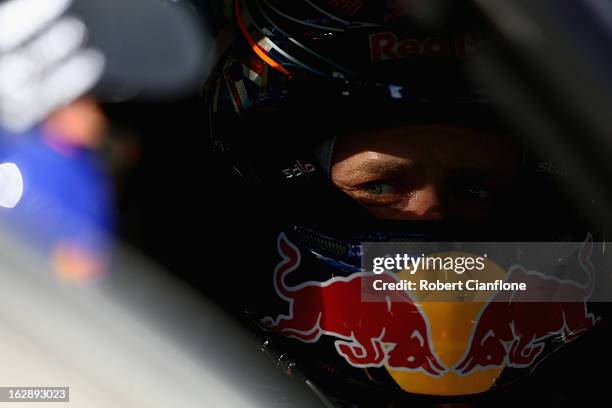 Casey Stoner driver of the Red Bull Pirtek Holden sits in his car prior to race one of round one of the V8 Supercars Dunlop Development Series at the...
