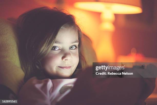 little girl peeking over tablet - green eyes stock pictures, royalty-free photos & images