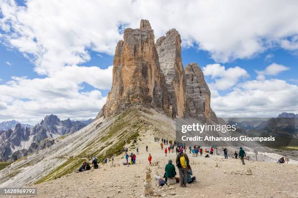 Mountain walkers admiring the Tre Cime di Lavaredo or the Drei Zinnen on August 07, 2023 in Tre Cime di Lavaredo, Italy. .
