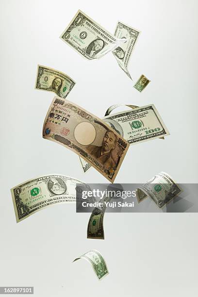 japan yen &us dollar  banknotes in the air - ten thousand yen note stock pictures, royalty-free photos & images