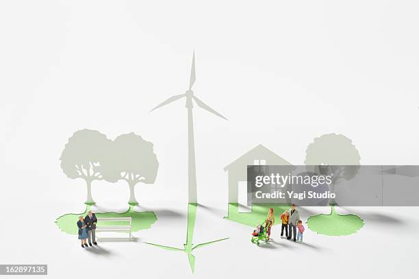 wind turbine and house made ??of paper - community figures stock pictures, royalty-free photos & images