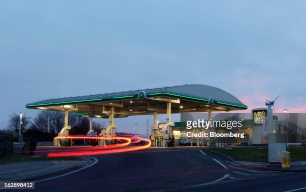 Light trails made by a vehicle are seen entering a BP gas station, operated by BP Plc, in Upminster, U.K., on Thursday, Feb. 28, 2013. BP Plc's push...
