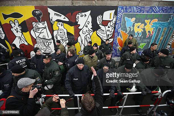 Protester argues with police at the East Side Gallery, which is the longest still-standing portion of the former Berlin Wall, following efforts by a...
