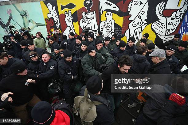 Protesters scuffle with police at the East Side Gallery, which is the longest still-standing portion of the former Berlin Wall, following efforts by...