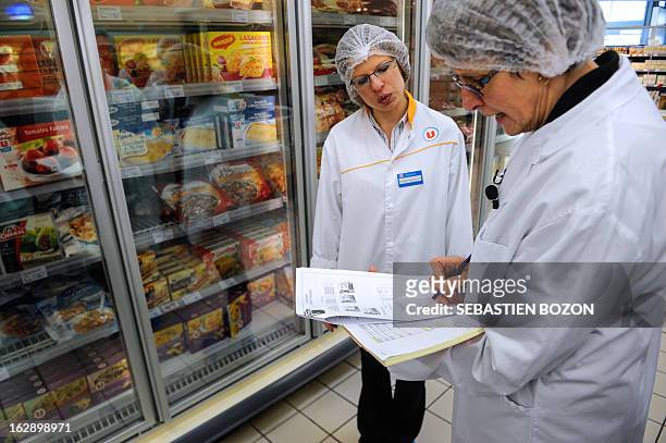 Employees of the DDCSPP conduct a verification of the origine of the meat in a supermarket in Besançon, eastern France, on March 1, 2013. An...