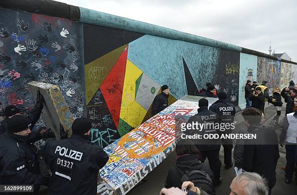 Police remove a piece of fake concrete used by protesters to fill out a whole during the removal of a section of the East Side Gallery, a 1,3 km long...