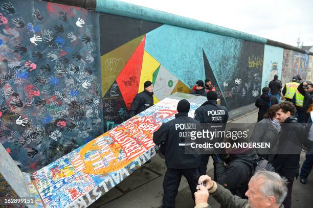 Police remove a piece of fake concrete used by protesters to fill out a whole during the removal of a section of the East Side Gallery, a 1,3 km long...
