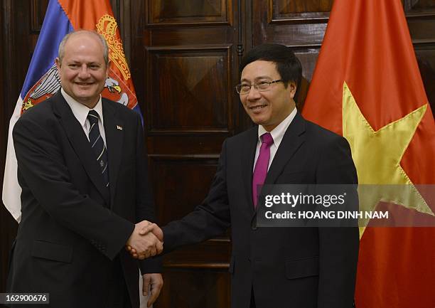 Visiting Serbian Foreign Minister Ivan Mrkic is greeted by his Vietnamese counterpart Pham Binh Minh in Hanoi on March 1, 2013. The Serbian diplomat...