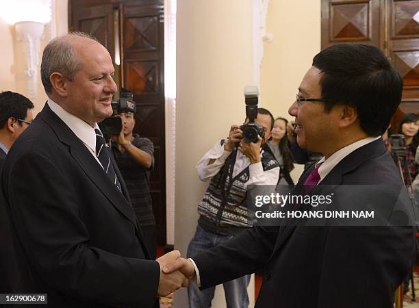 Visiting Serbian Foreign Minister Ivan Mrkic is greeted by his Vietnamese counterpart Pham Binh Minh in Hanoi on March 1, 2013. The Serbian diplomat...