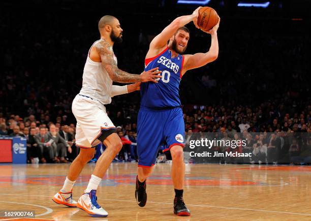 Spencer Hawes of the Philadelphia 76ers in action against Tyson Chandler of the New York Knicks at Madison Square Garden on February 24, 2013 in New...