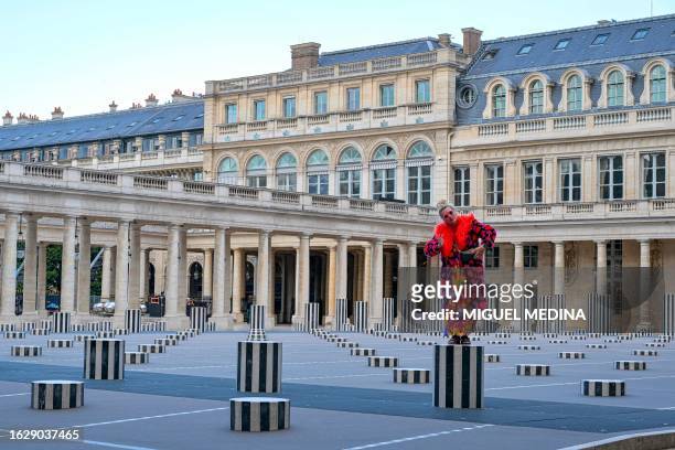 An artist performs on "Les Deux Plateaux", commonly known as "Columns of Buren", by French artist Daniel Buren and architect Patrick Bouchain, in the...