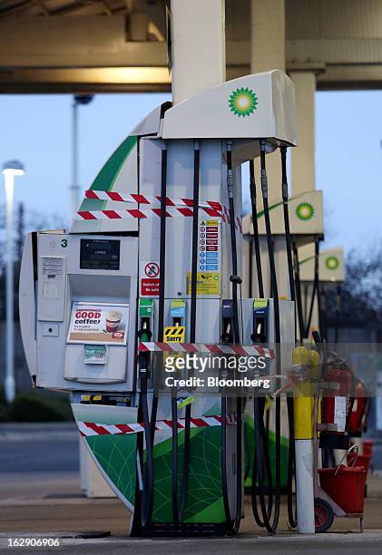 Warning tape stops customers from using gas and diesel fuel nozzles on the forecourt of a BP gas station, operated by BP Plc, in Upminster, U.K., on...
