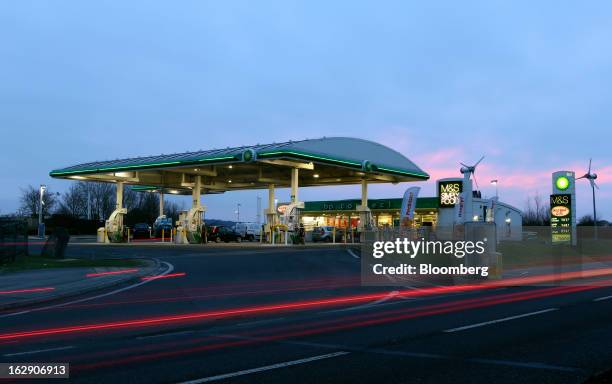 Light trails made by passing vehicles are seen in front of a BP gas station, operated by BP Plc, in Upminster, U.K., on Thursday, Feb. 28, 2013. BP...