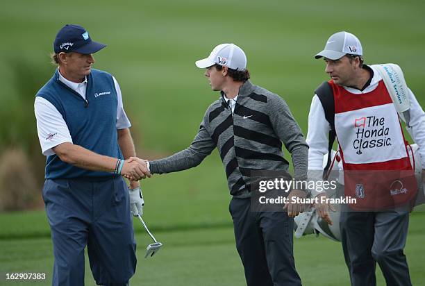 World number one and defending champion, Rory McIlroy of Northern Ireland shakes hands with Open champion Ernie Els of South Africa as he walks off...