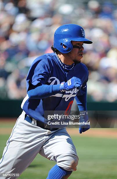 Alfredo Amezaga of the Los Angeles Dodgers runs to first base during the game against the Chicago Cubs on February 27, 2013 at HoHoKam Park in Mesa,...