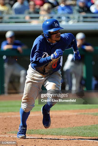 Alfredo Amezaga of the Los Angeles Dodgers runs to first base during the game against the Chicago Cubs on February 27, 2013 at HoHoKam Park in Mesa,...