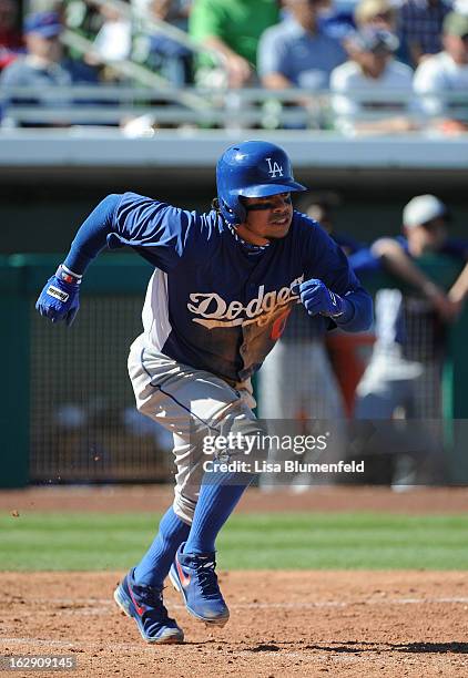 Alfredo Amezaga of the Los Angeles Dodgers runs to first base during the game against the Chicago Cubs on February 27, 2013 at HoHoKam Park in Mesa,...