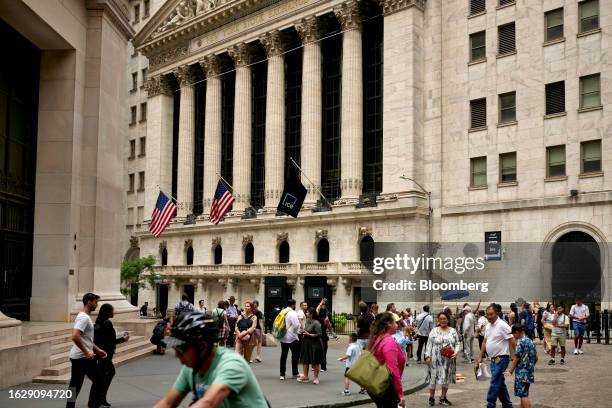 Pedestrians near the New York Stock Exchange in New York, US, on Monday, Aug. 28, 2023. Stocks advanced, while bond yields retreated at the start of...