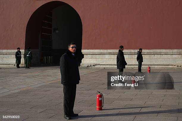 Chinese plainclothes police officers guard in front of the Tiananmen Gate on March 1, 2013 in Beijing, China. The reshuffle will be completed at the...