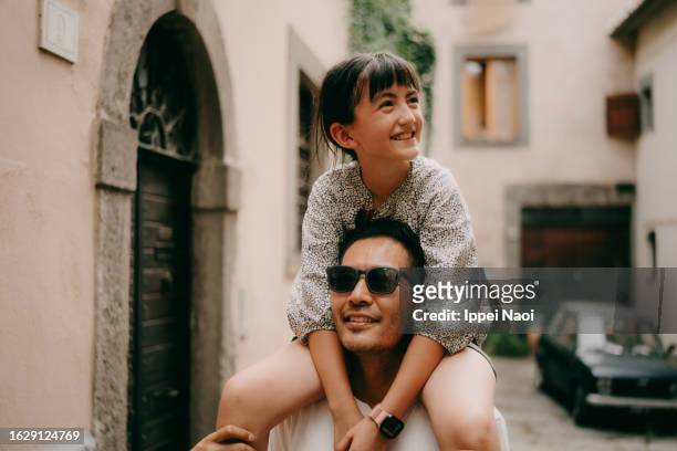father and young daughter having fun in viterbo, italy - travel photos et images de collection