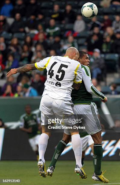 Daniel Majstorovic of AIK goes up for a ball with Ryan Johnson of the Portland Timbers during the first half of the game at Jeld-Wen Field on...