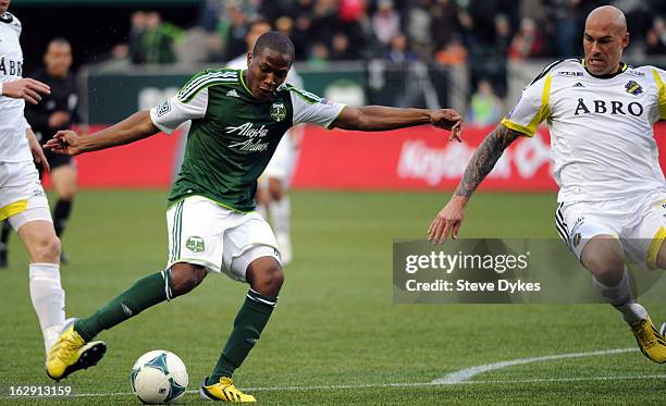 Darlington Nagbe of the Portland Timbers puts a shot on goal as Daniel Majstorovic of AIK closes in during the first half of the game at Jeld-Wen...