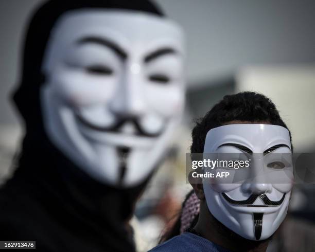 Bahraini protesters wearing Guy Fawkes masks used by the Anonymous movement take part in a demonstration against the government and in solidarity...