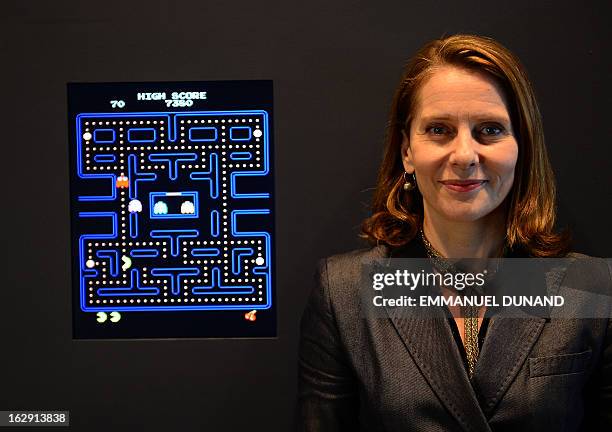 The Museum of Modern Art Senior Curator of Architecture and Design Paola Antonelli poses next to the video game Pac-Man during a preview of the...