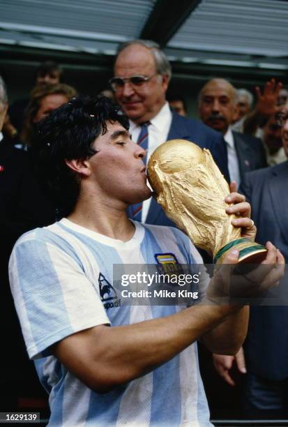 Diego Maradona of Argentina kisses the trophy after the World Cup final against West Germany at the Azteca Stadium in Mexico City. Argentina won the...