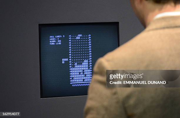 Visitor plays the video game Tetris during an exhibition preview featuring 14 video games acquired by The Museum of Modern Art in New York, March 1,...