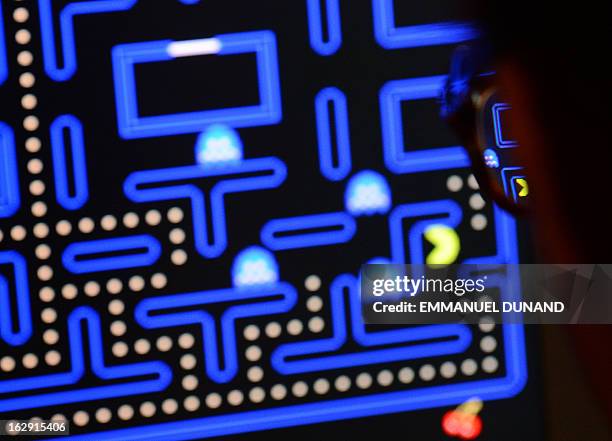 An employee plays the video game Pac-Man during an exhibition preview featuring 14 video games acquired by The Museum of Modern Art in New York,...
