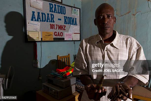 Director of radio AADAR-Koima programmes Souleima Maiga holds munitons found in Gao on February 28, 2013. Gao, the main town in northern Mali, which...