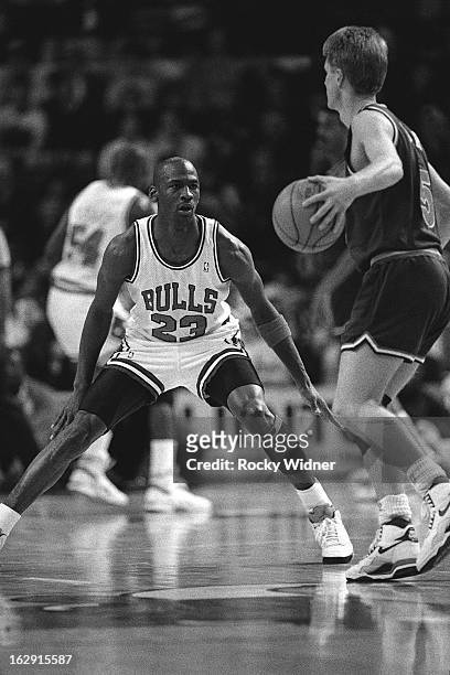 Michael Jordan of the Chicago Bulls defends against the Cleveland Cavaliers during a game played on March 23, 1990 at Chicago Stadium in Chicago,...