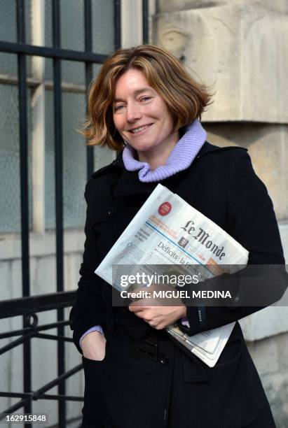 French journalist Natalie Nougayrede holds Le Monde newspaper while posing on February 22, 2013 in Paris. Nougayrede the newly elected director of...