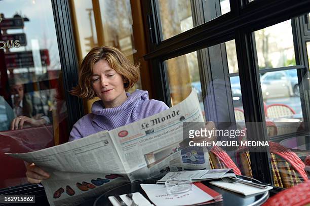 French journalist Natalie Nougayrede holds Le Monde newspaper while posing on February 22, 2013 in Paris. Nougayrede the newly elected director of...