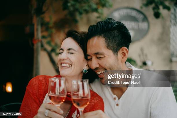 couple enjoying wine in italy - restaurant happy couple stock pictures, royalty-free photos & images