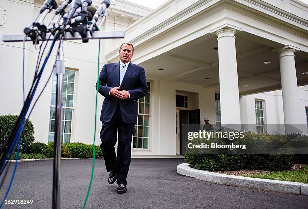 House Speaker John Boehner, a Republican from Ohio, walks toward a bank of microphones as he prepares to speak to the media outside the West Wing of...