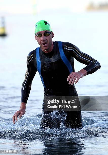 Bervan Docherty of New Zealand leaves the water after the swim leg during the New Zealand Ironman on March 2, 2013 in Taupo, New Zealand.